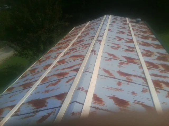 Rusted metal roof panels with new wood purlins before replacement — Storm Damage Roof Repair in Blountstown by Roofing Brothers